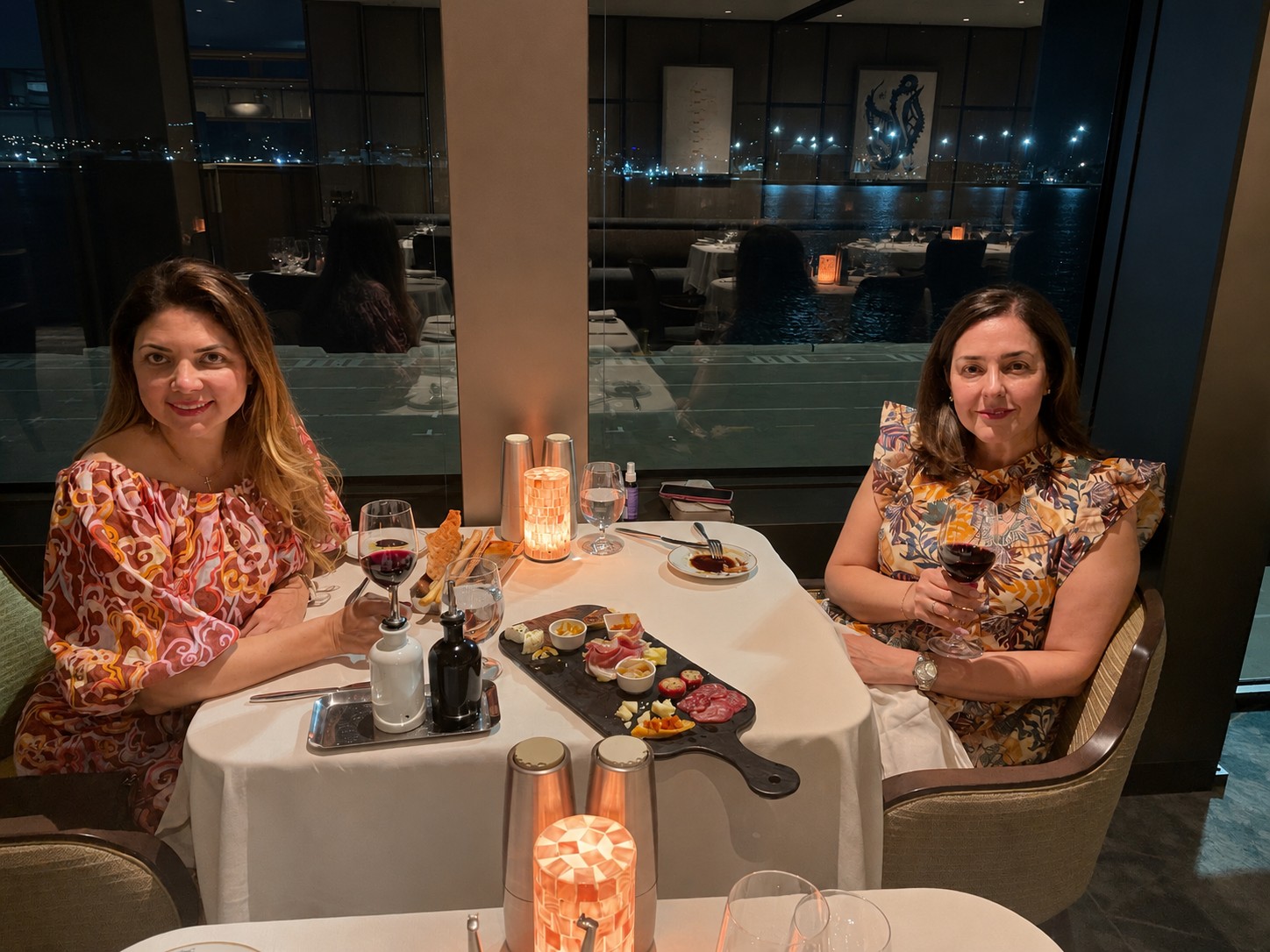 Two guests dining at night aboard Silversea's Silver Nova